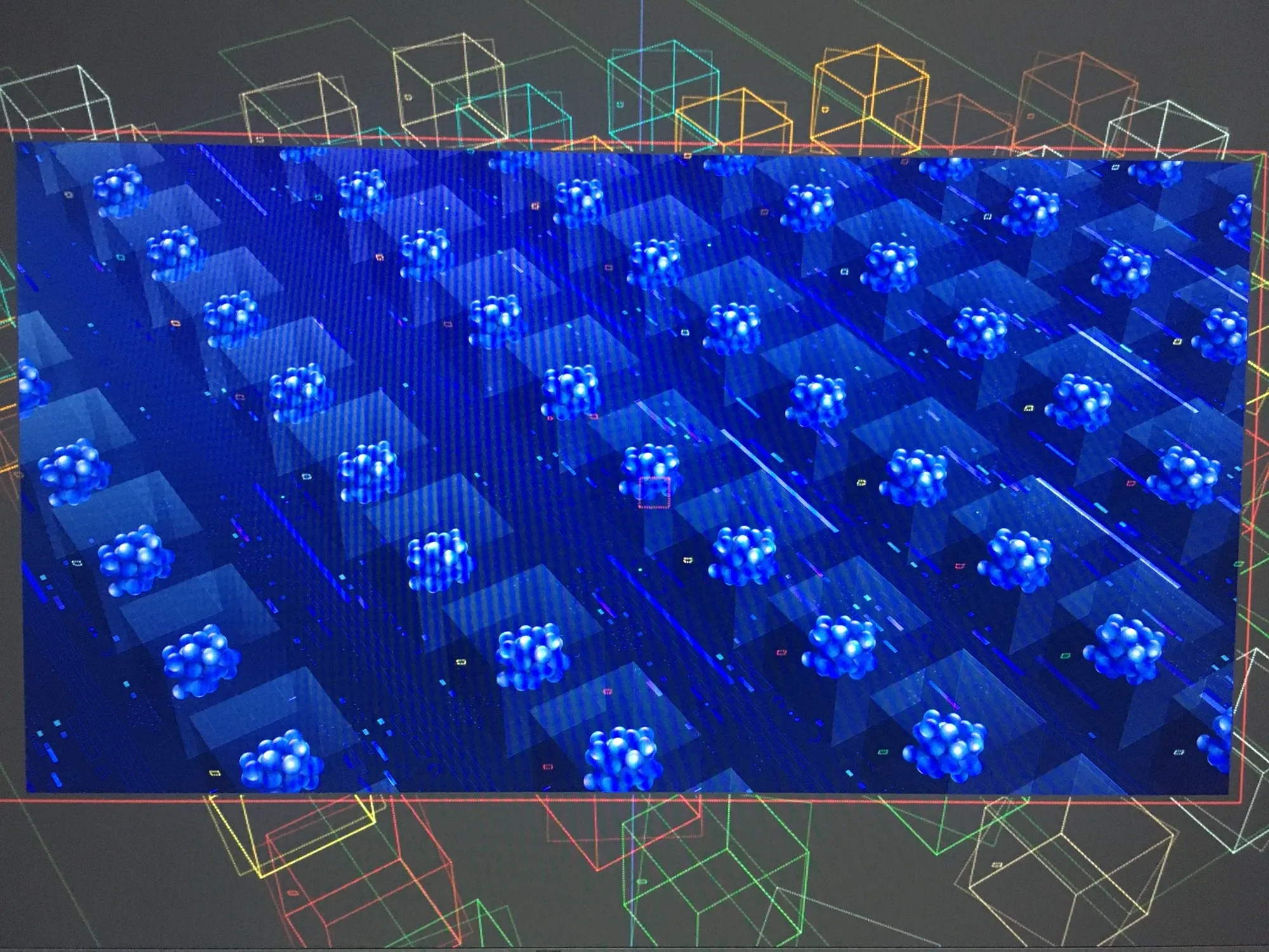 A close-up of a screen rendering the blue molecular-cluster animation inside a wireframe 3D viewport.