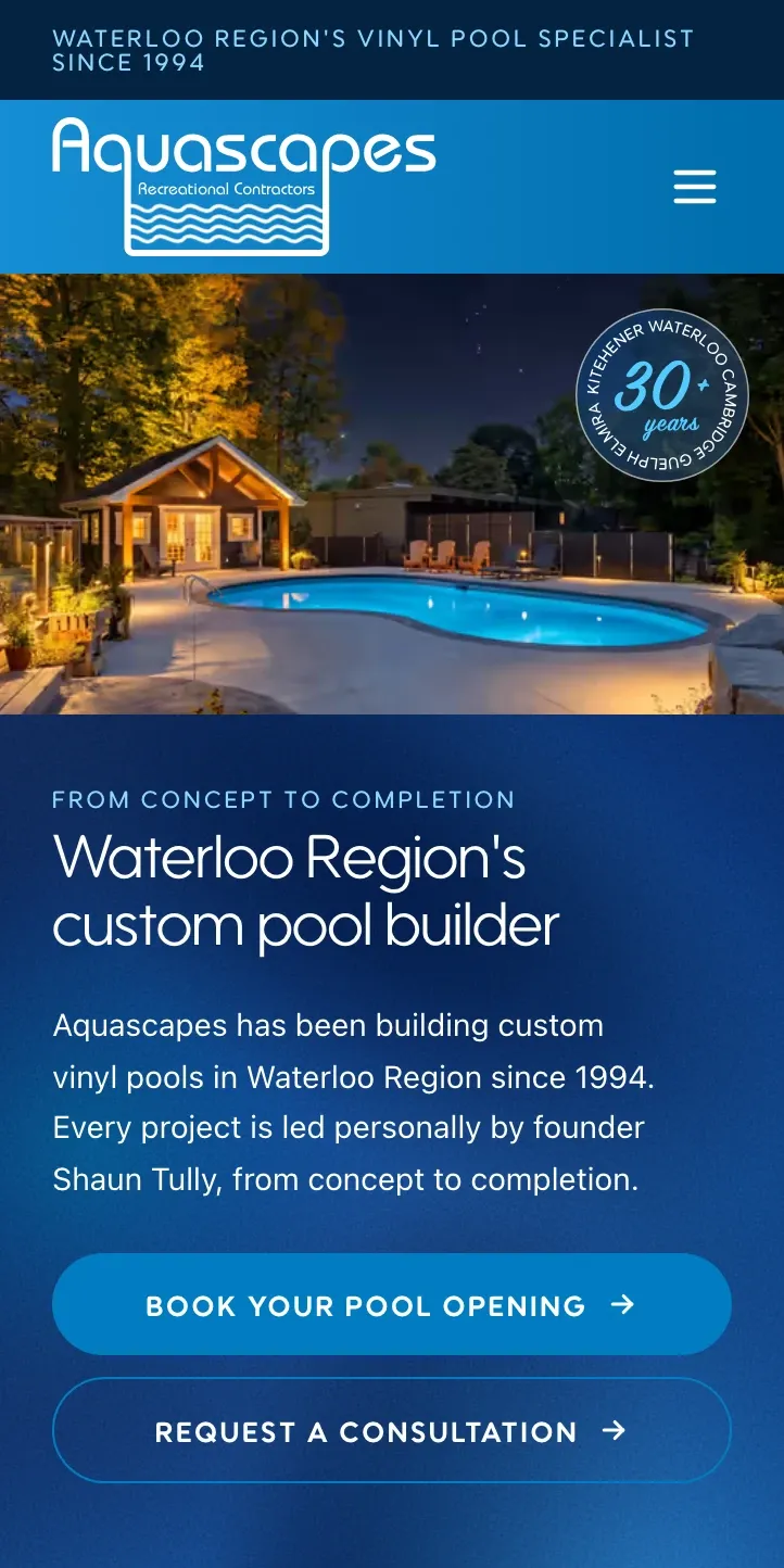 The Aquascapes home page at phone width: a dusk pool and cabana photo under the Waterloo Region custom pool builder headline, with booking and consultation buttons.